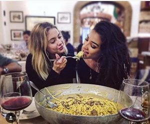 girls feeding each other pasta