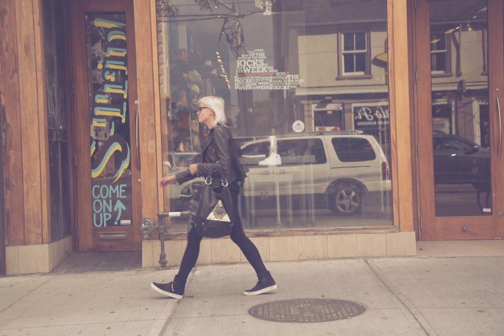 woman walks in front of store in queen street west