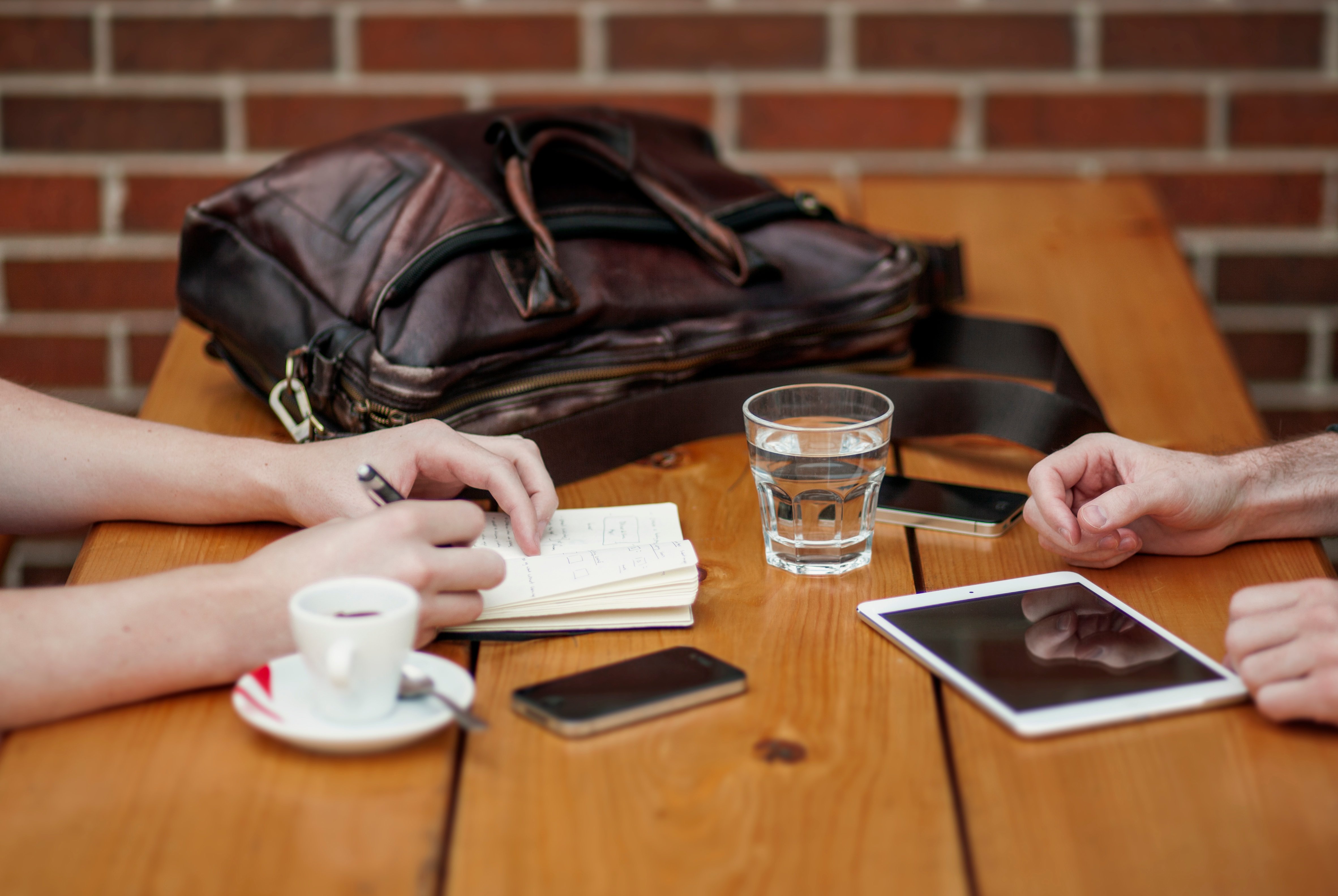 hands on table in cafe making plans 