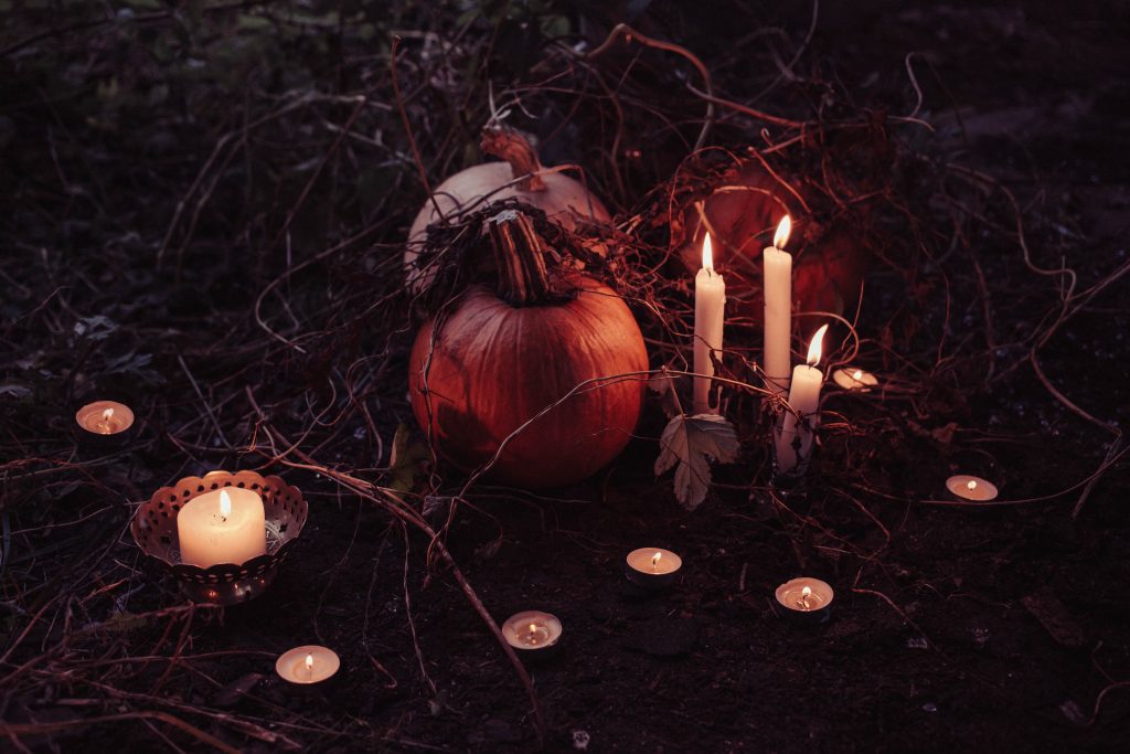 pumpkins surrounded by candles