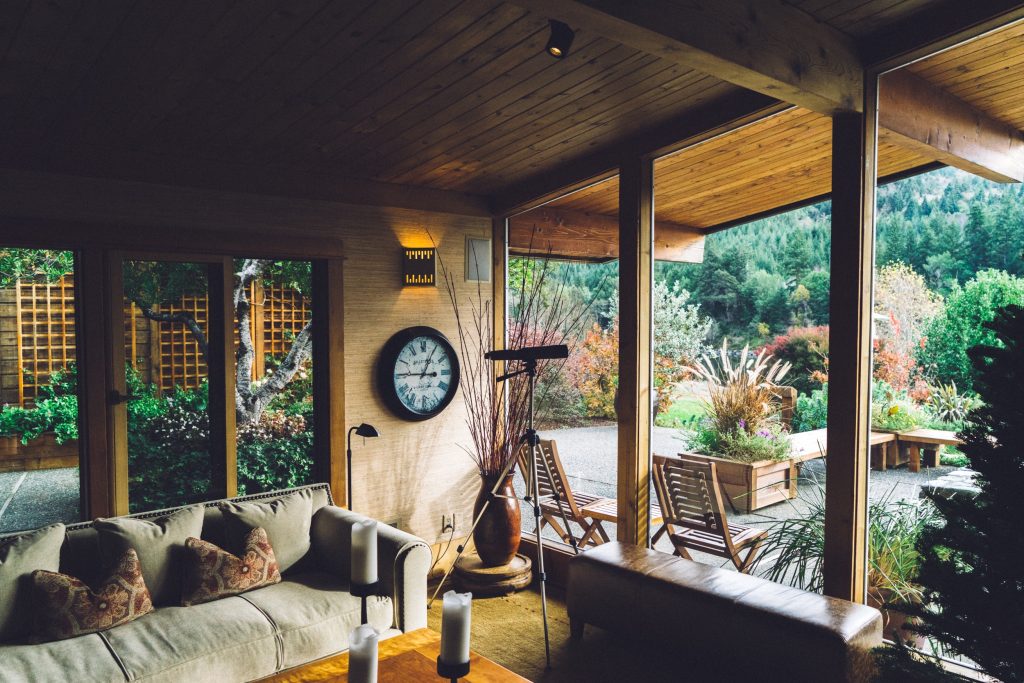 Living room of house on the first floor with wooden theme and looking out into a garden through large windows