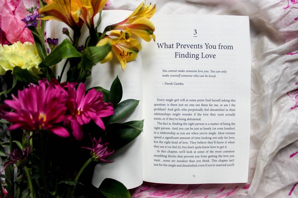 book open on chapter three "what prevents you from finding love" with flowers 