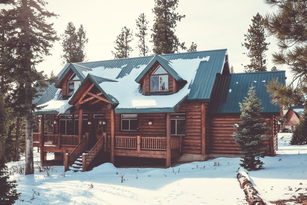 log cabin in forest during winter